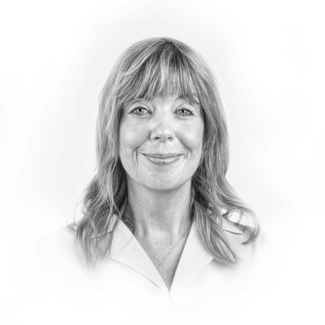 Portrait of a Swiss woman in her forties, editor in chief, smiling warmly
